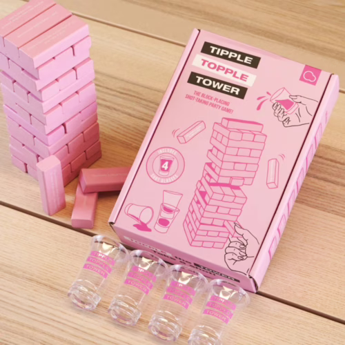 Tipple Topple Tower game box and shot glasses, on a wooden surface