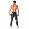 A man with a muscular build wearing black Tof Paris Kinky Cargo Sweat Pants