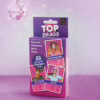 Celebrate your favorite drag queens with the Top Drags card game, available at The Loving Company. Bubblegum Stuff Top Drags Card Game box with drag queens' images and stats