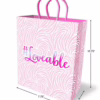 Pink gift bag with swirl pattern and '#Loveable' text